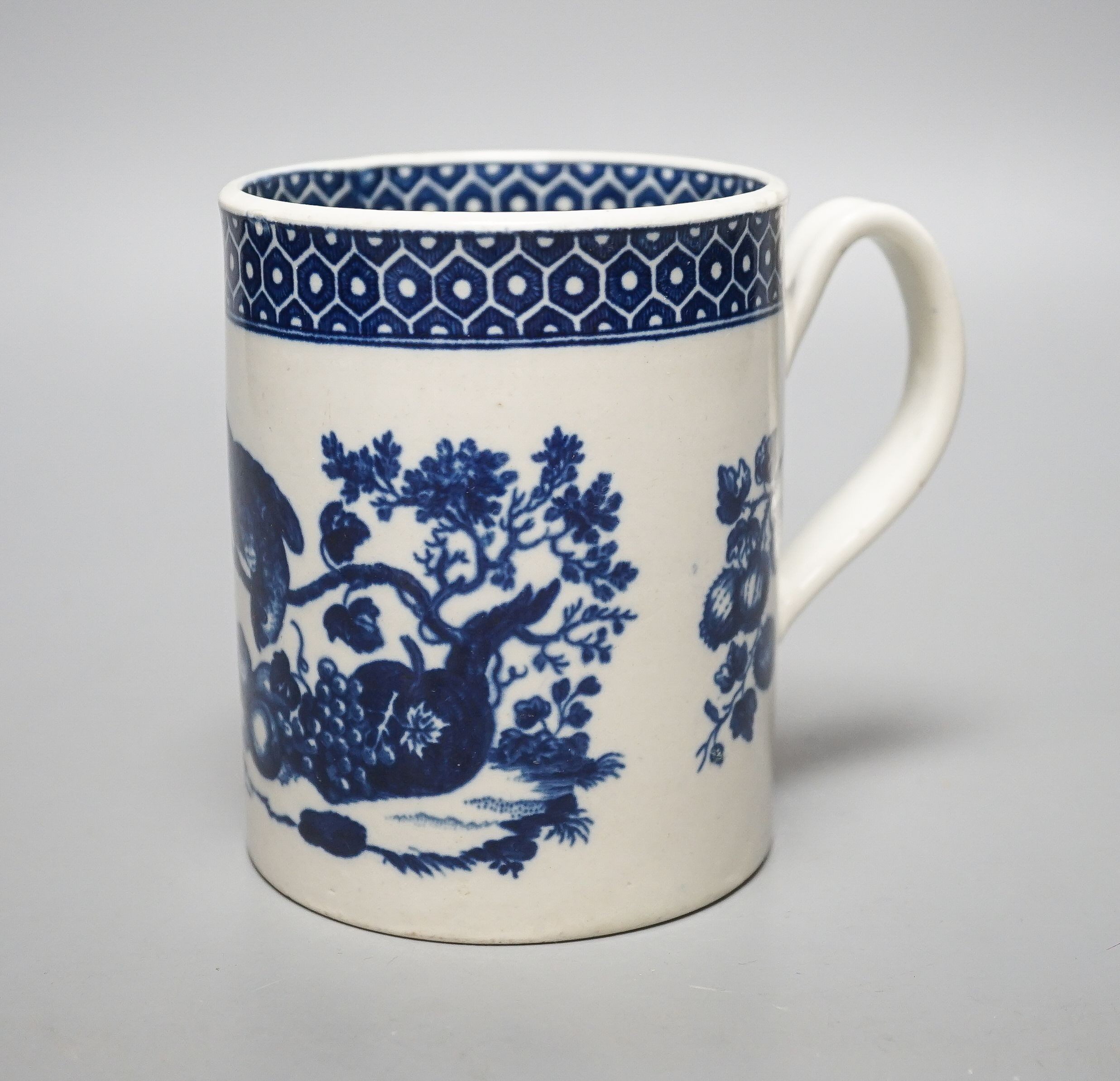 A Worcester cylindrical mug, parrot pecking fruit pattern c.1770, 11.5cm high